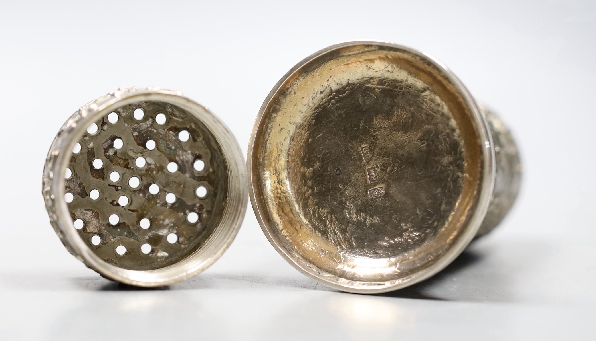 A late 19th/early 20th century Chinese Export white metal cylindrical sugar caster by Wang Hing, Hong Kong, decorated with prunus, 12.1cm, 170 grams.